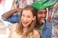 Young multiracial couple at the weekly cloth market - Best multi ethnic friends having fun and shopping in the old town - Concept Royalty Free Stock Photo