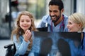 Young multiracial doctor with his colleague showing x-ray image of lungs to little girl on wheelchair. Royalty Free Stock Photo