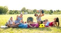 Young multiracial families having fun playing with kids at pic nic garden party - Multiethnic joy and love concept