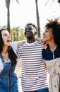 Young multiracial friends having fun during summer vacation outdoors.