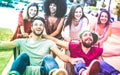 Young multiracial friends having fun together with shopping cart - Millennial people sharing time with trolleys at commercial mall Royalty Free Stock Photo