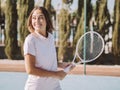 Young multiracial girl smiling with a tennis racket Royalty Free Stock Photo