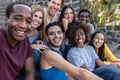 Young multiracial group of friends taking selfie sitting on urban stairs Royalty Free Stock Photo