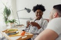 Young multiracial love couple having breakfast in bed Royalty Free Stock Photo