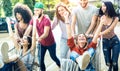 Young multiracial people having fun together with shopping cart - Millenial friends sharing time with trolleys at commercial mall