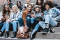 Young multiracial people using mobile phones outdoor - Main focus on girl face with grey hat Royalty Free Stock Photo