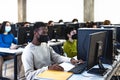 Young multiracial students taking an exam in high school while wearing face mask during corona virus pandemic