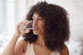 Young multiracial woman drinking water daily morning habit routine after morning exercise Royalty Free Stock Photo