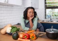 A young multiracial woman is tired and uninspired while preparing dinner Royalty Free Stock Photo