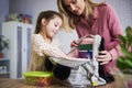 Young mum and daughter packing backpack for the school Royalty Free Stock Photo