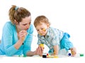 Young mum draws with the son paints Royalty Free Stock Photo