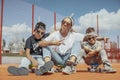 Young mum sitting with her sons at playground. Happy family concept. Royalty Free Stock Photo