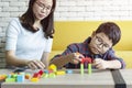 Young mummy and her kid son play with cubes toys Royalty Free Stock Photo