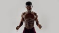 Young muscular african american man looking at camera, while holding jumping rope isolated over grey background. Sports Royalty Free Stock Photo