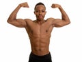 Young muscular African man flexing both arms Royalty Free Stock Photo