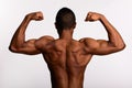 Young muscular African man shirtless flexing both arms Royalty Free Stock Photo