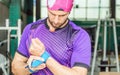 Young muscular athlete puts palm protection grips on