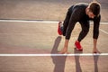 Athlete on starting position at running track. Runner practicing run in stadium racetrack Royalty Free Stock Photo