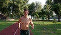 young muscular athletic man runs in the park, energizer