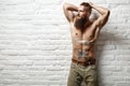 Young muscular bearded white man half naked