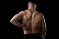 Young muscular body sport man holding sore low back waist are suffering pain in athlete stress Royalty Free Stock Photo