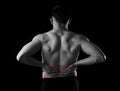 Young muscular body sport man holding sore low back waist are suffering pain in athlete stress Royalty Free Stock Photo