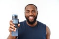 Young muscular build man hold bottle water after running, attractive athlete resting after workout outdoors, fitness and Royalty Free Stock Photo