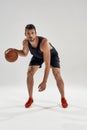 Young muscular caucasian basketball player leading ball