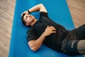 Young muscular caucasian handsome man doing abs exercises on mat Royalty Free Stock Photo