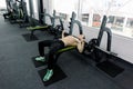 Young muscular Caucasian man lifting barbell on the bench in the gym. Royalty Free Stock Photo