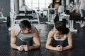 Young muscular couple doing doing hard workout at the gym. Doing plank in the gym Royalty Free Stock Photo