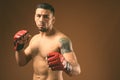 Young muscular Hispanic man shirtless ready for martial arts