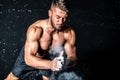 Young muscular man with big sweaty muscles doing push ups workout training with clap his hand above the barbell weight plate on th Royalty Free Stock Photo
