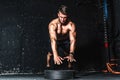 Young muscular man with big sweaty muscles doing push ups workout training with jump his hand above the barbell weight plate on th Royalty Free Stock Photo