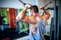young, muscular man, bodybuilder working out in gym Royalty Free Stock Photo