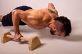 A young muscular man is doing push-ups on parapets Royalty Free Stock Photo