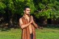 Young muscular man doing yoga on grass wearing a cap Royalty Free Stock Photo