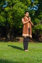 Young muscular man doing yoga on grass wearing a cap Royalty Free Stock Photo