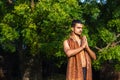 Young muscular man doing yoga on grass wearing a cap Royalty Free Stock Photo