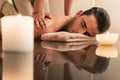 Young man enjoying the healing benefits of traditional Thai massage Royalty Free Stock Photo