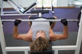 Young muscular man lifting barbell in gym Royalty Free Stock Photo