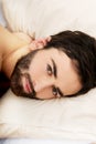 Young muscular man lying in bed. Royalty Free Stock Photo