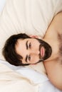 Young muscular man lying in bed. Royalty Free Stock Photo