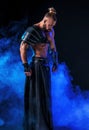 Young and muscular man performing a theatrical pose on stage. Royalty Free Stock Photo