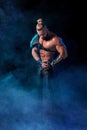 Young and muscular man performing a theatrical pose on stage. Royalty Free Stock Photo