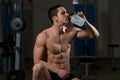 Young Muscular Men Drinking A Water Bottle Royalty Free Stock Photo