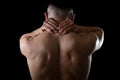 Young muscular sport man holding sore neck massaging cervical area suffering body pain Royalty Free Stock Photo