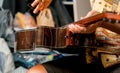 Young musician changing strings on a classical guitar in a guitar shop Royalty Free Stock Photo