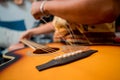 Young musician changing strings on a classical guitar in a guitar shop Royalty Free Stock Photo