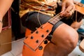 Young musician changing strings on a classical guitar in a guitar shop Royalty Free Stock Photo